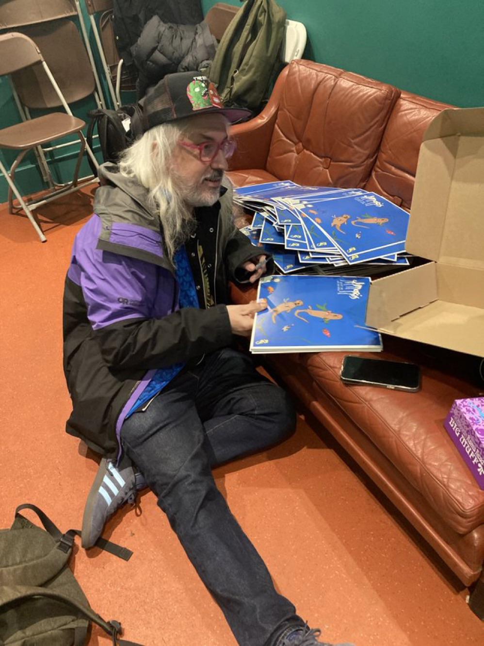 J Signing copies of 'What Do We Do Now'